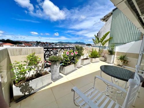 a patio with a table and chairs on a balcony at Tulip Hotel 3 in Da Lat