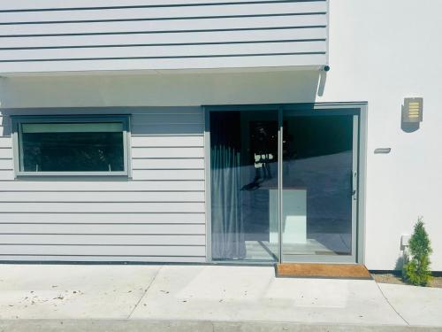 an entrance to a building with a glass door at Alpine Rest! Brand new! Cozy&Convenient! in Queenstown