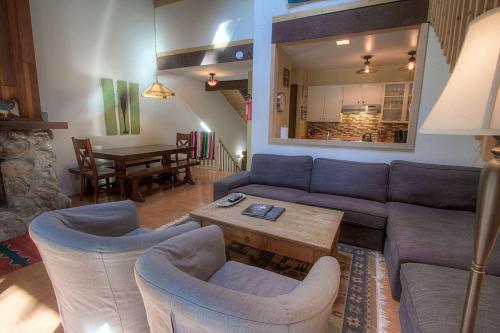 a living room with a couch and chairs and a table at Alpine Getaway home in Tahoe City