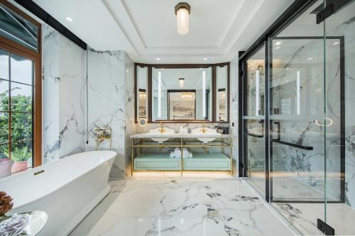 a bathroom with a tub and a sink at CHONGQING MANQUE MANSION in Chongqing