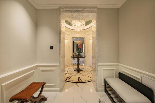 a hallway with a clock in the corner of a room at CHONGQING MANQUE MANSION in Chongqing
