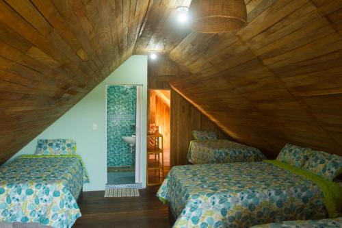 a room with two beds and a sink in it at Hotel Calamari Baru in Playa Blanca