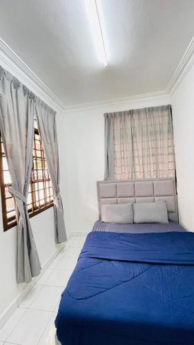 a blue bed in a white room with two windows at Rinting Masai Semi-D Snooker Ping Pong 6R 20 Paxs in Masai