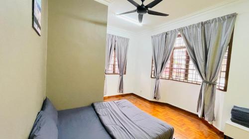a bedroom with a bed and two windows at Rinting Masai Semi-D Snooker Ping Pong 6R 20 Paxs in Masai