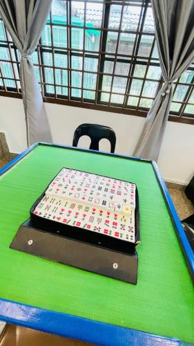 a green ping pong table with a cake on it at Rinting Masai Semi-D Snooker Ping Pong 6R 20 Paxs in Masai