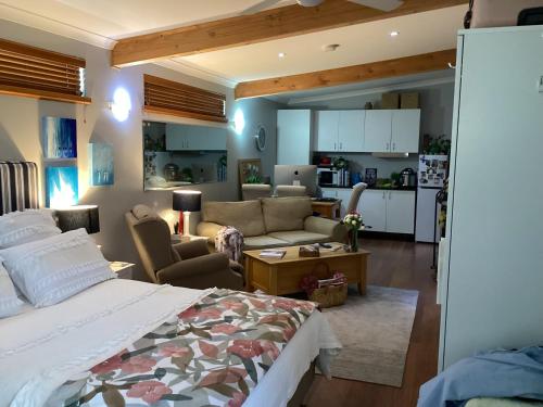 a bedroom with a bed and a living room at AC 1 Bed Studio Apartment 25+ Non Smokers in Warnbro