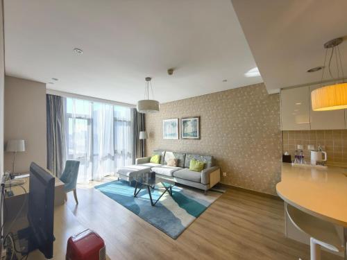 a living room with a couch and a table at Holiday Inn Express Beijing Yizhuang by IHG - Taxi 1 Hour to International Airport and 800 Meters to the Nearby Subway in Daxing