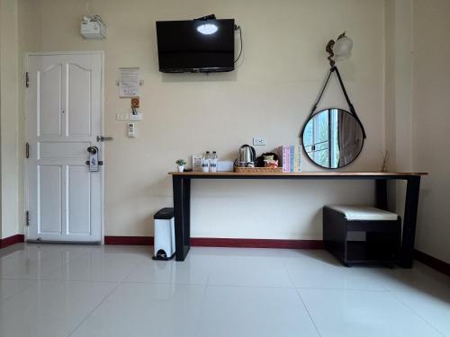 a room with a table with a mirror and a mirror at Aivarata Resort in Ban Phra Trong