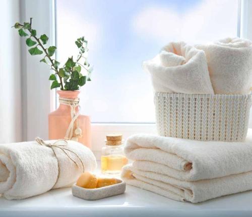 a pile of towels sitting on a counter with a window at Meson Cavour in Avigliano