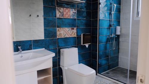 a bathroom with a toilet and a sink and a shower at Xiaoliuqiu Loju Castle Inn in Xiaoliuqiu
