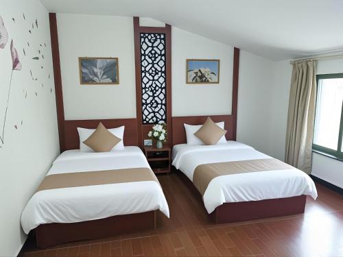 Postel nebo postele na pokoji v ubytování Junyao Inn