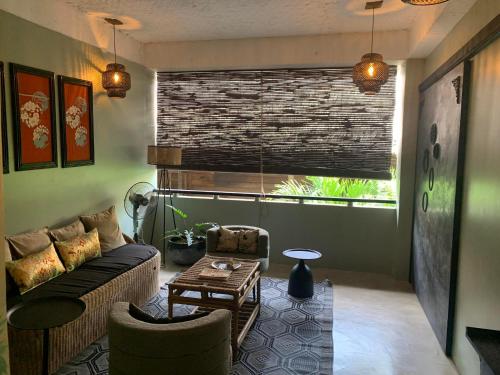 a living room with a couch and a table at La Plage Hotel in El Nido