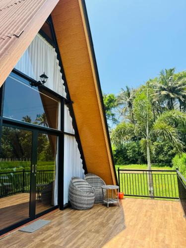a large glass door on a house with a deck at Lombok Hidden Villa in Tetebatu