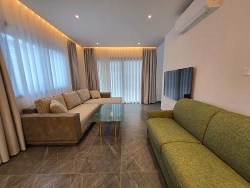 a living room with a couch and a table at TG NEW Luxury Private Resort & SPA Villas - Heated Salty Swimming Pool, Outdoor Jacuzzi, Sauna, Exotic Garden in Limassol