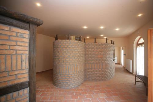 a room with brick walls and two wine barrels at Napvirág-Ház in Zsira