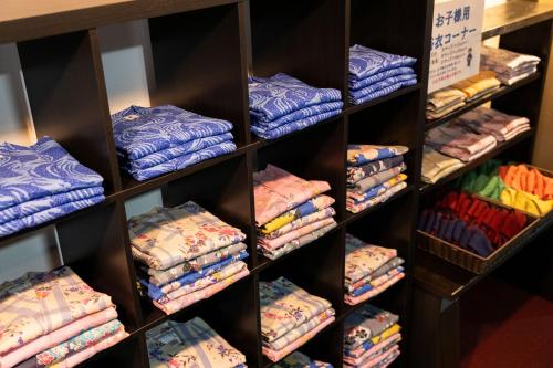 a shelf full of shirts in a store at Aso Baien Spa Resort in Minami Aso