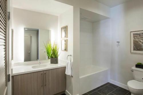 a bathroom with a sink and a toilet and a mirror at A-Class Highland 2 Bed Apt in Hollywood CA with FREE PARKING in Los Angeles