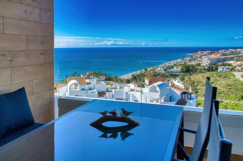 a view of the ocean from the balcony of a villa at New sunset views in Torrox Costa