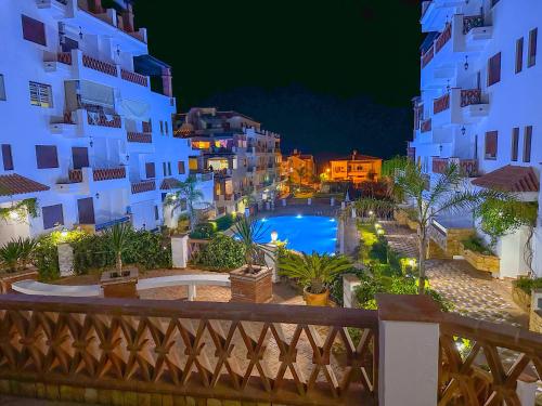 a view of a pool at night with buildings at Apartment Residence Al Kassaba, Beach, Pool, Fast Wifi in Oued Laou