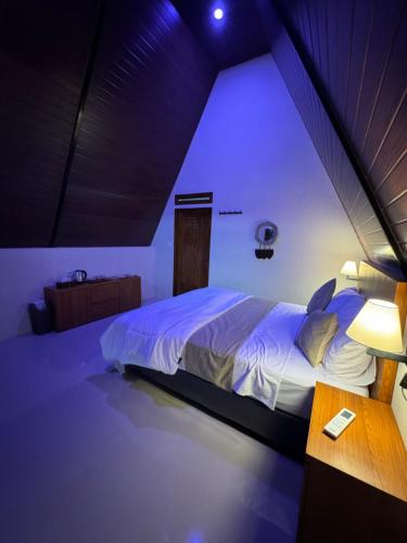 a bedroom with a large bed and a table at Lombok Hidden Villa in Tetebatu