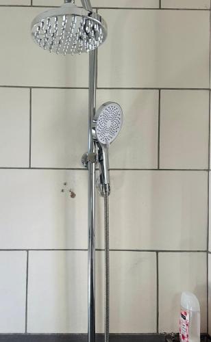 a shower with a shower head in a bathroom at Nadi Homes in Dar es Salaam
