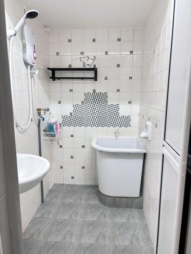 a white bathroom with a tub and a sink at 8 Paddy Escape Alor Setar, INS-Style, 3R 1B1T, Kid Toys, Bikes Rent in Simpang Empat