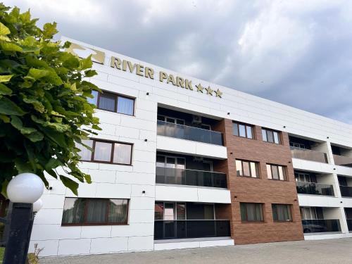 a white building with a sign that reads ranger park at River Park Hotel in Drăgăşani