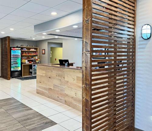 a lobby with a wooden wall in front of a counter at Country Inn & Suites by Radisson Rehoboth Beach - Dewey in Rehoboth Beach