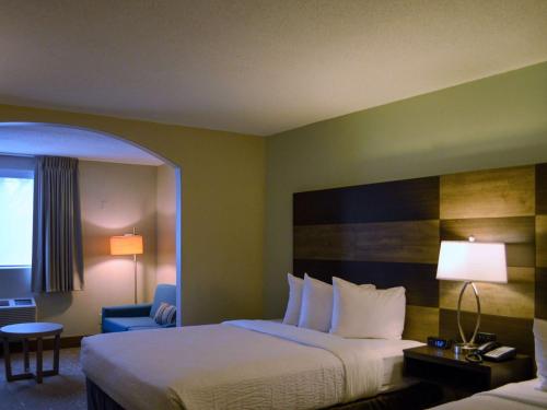 a hotel room with a bed and a chair at Country Inn & Suites by Radisson Rehoboth Beach - Dewey in Rehoboth Beach