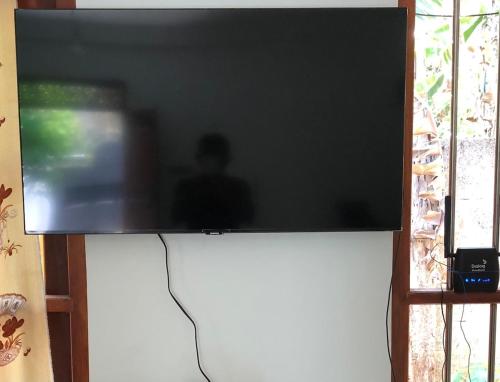 a flat screen tv sitting on top of a wall at Haven house with AC in Kamburugamuwa
