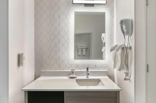 a bathroom with a sink and a mirror at Comfort Suites Redmond Airport in Redmond