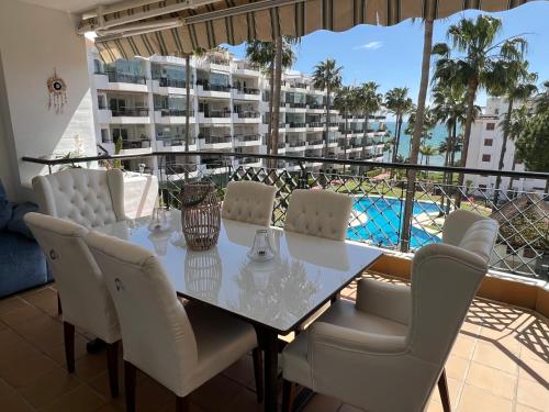 a dining room with a table and chairs on a balcony at Mi Capricho, Luxury Apartment in Mijas Costa