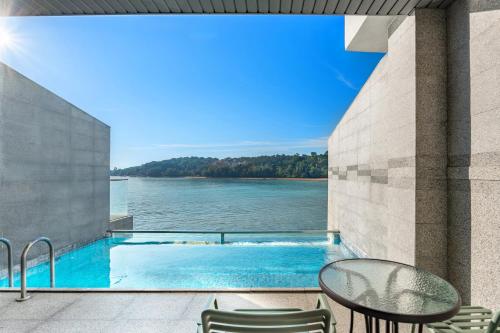 a swimming pool with a view of the water at Lexis Hibiscus Port Dickson in Port Dickson