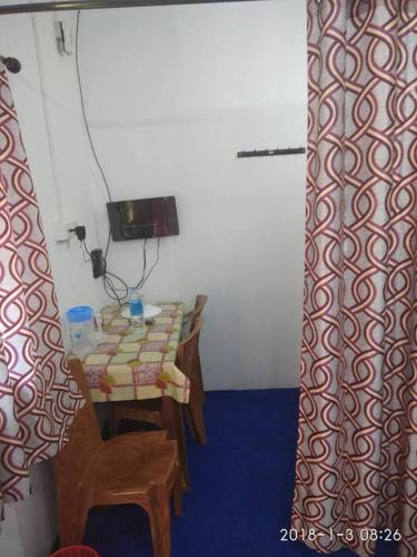 a small room with a table and a curtain at Sunleo Villas in Anachal
