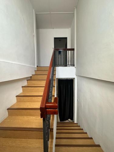 a staircase in a building with a laptop on it at Tang's Crib in Miri