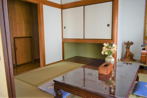 a living room with a table and a mirror at Near the sea House 2nd two-story detached house in Hannan