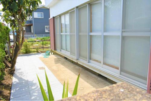a building with windows on the side of it at Near the sea House 2nd two-story detached house in Hannan