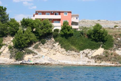 a house on an island in the water at Apartmani Sara in Vlašići