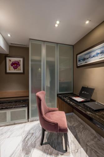 a office with a pink chair and a desk at Lexis Hibiscus Port Dickson in Port Dickson