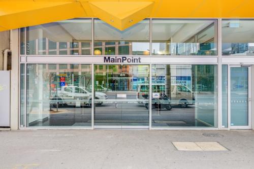 a store front with glass doors with cars in a parking lot at Mega Style Apartments Mainpoint in Melbourne