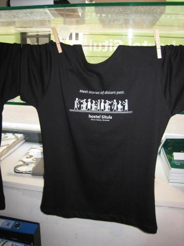 a black t shirt hanging on a clothes line at Hostel Situla in Novo Mesto