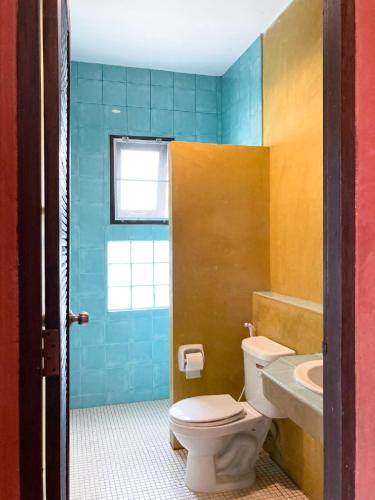 a bathroom with a toilet and a sink at Flora Ville-SHA PLUS in Chalong
