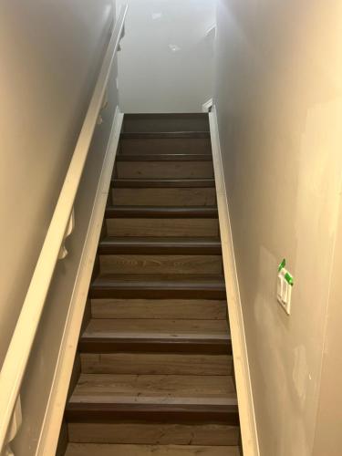 a staircase in a room with a stair case at Basement Suite Near Edmonton Airport YEG in Edmonton
