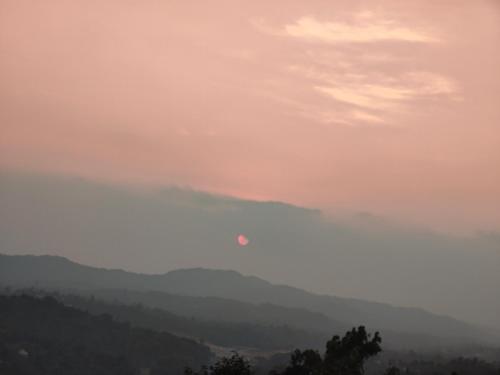 a view of a valley with mountains in the distance at View Point Stay in Madikeri