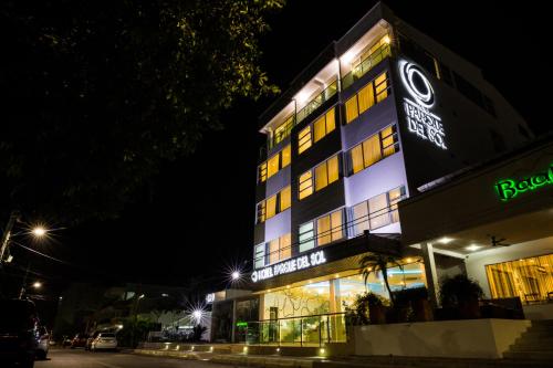 a building with a sign on it at night at Hotel Parque Del Sol in Montería
