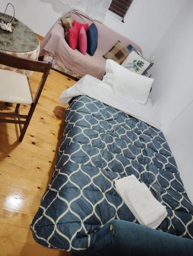 a bedroom with a bed and a table and chairs at σπίτι - αγρόκτημα - Δ Γεωργά Χατζηράση οδός Χατζηράση in Porto Heli