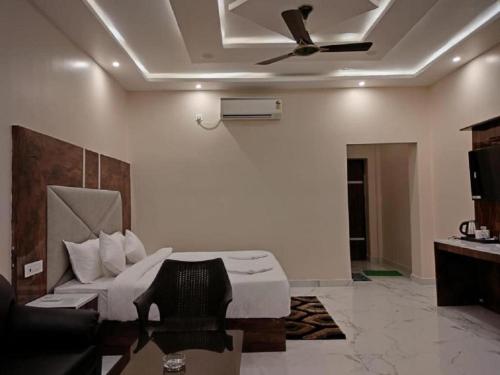 a bedroom with a bed and a ceiling fan at The Sea Horse in Mandarmoni