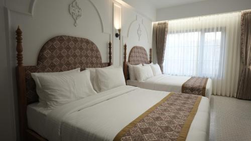 Postel nebo postele na pokoji v ubytování Haldi Kumkum Resort