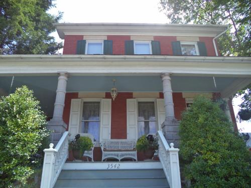 a red and white house with a bench on the porch at The Inn & Spa at Intercourse Village in Intercourse
