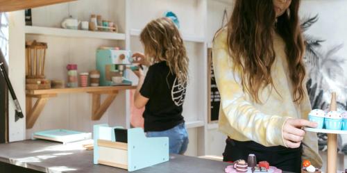 a woman taking a picture of a girl in a kitchen at Sea Notes Yamba in Yamba